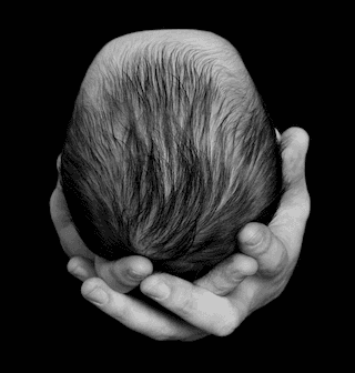 Baby head and dads hands